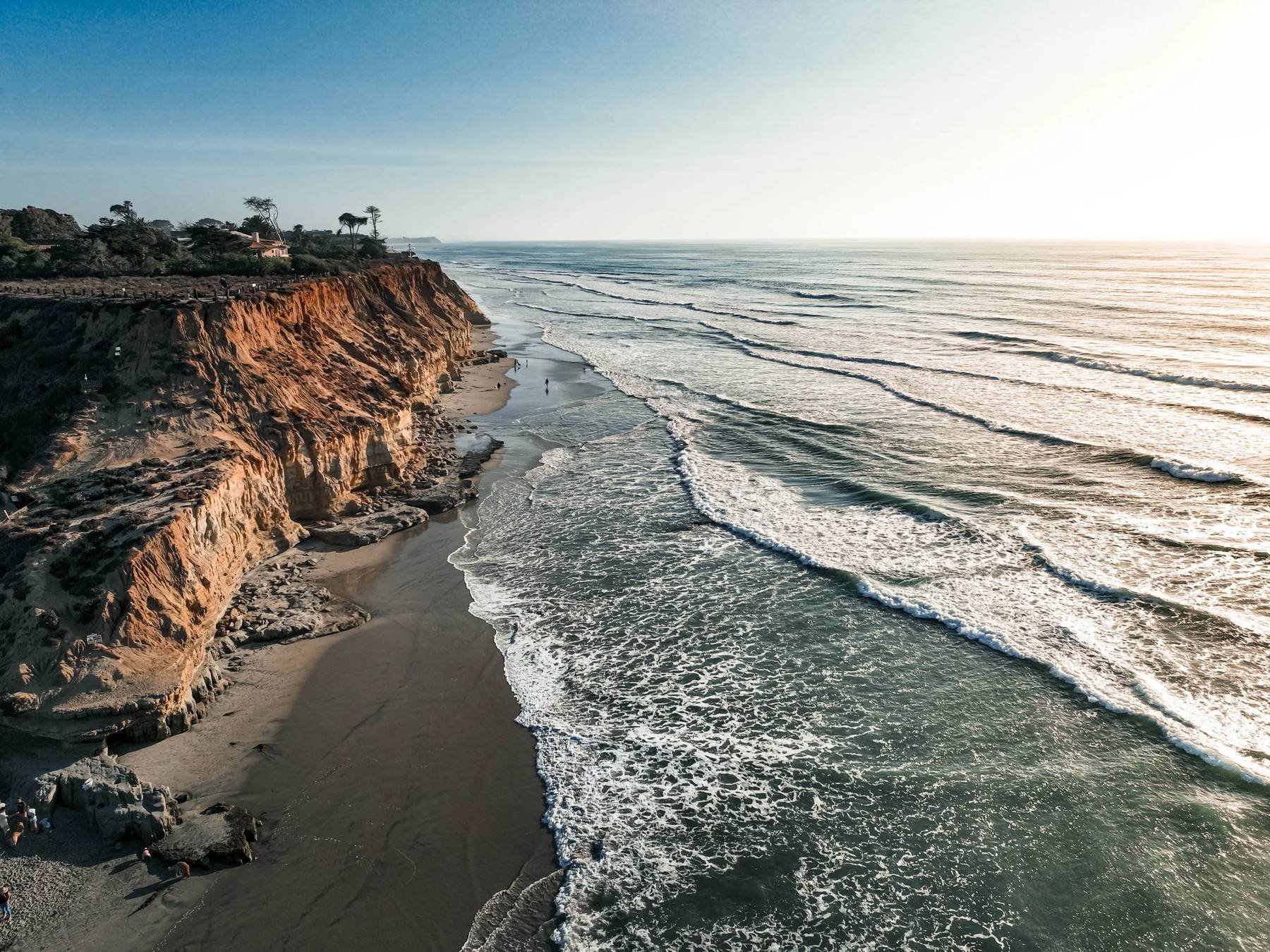 Aerial view of coastal bluffs and surf along the Southern California coast