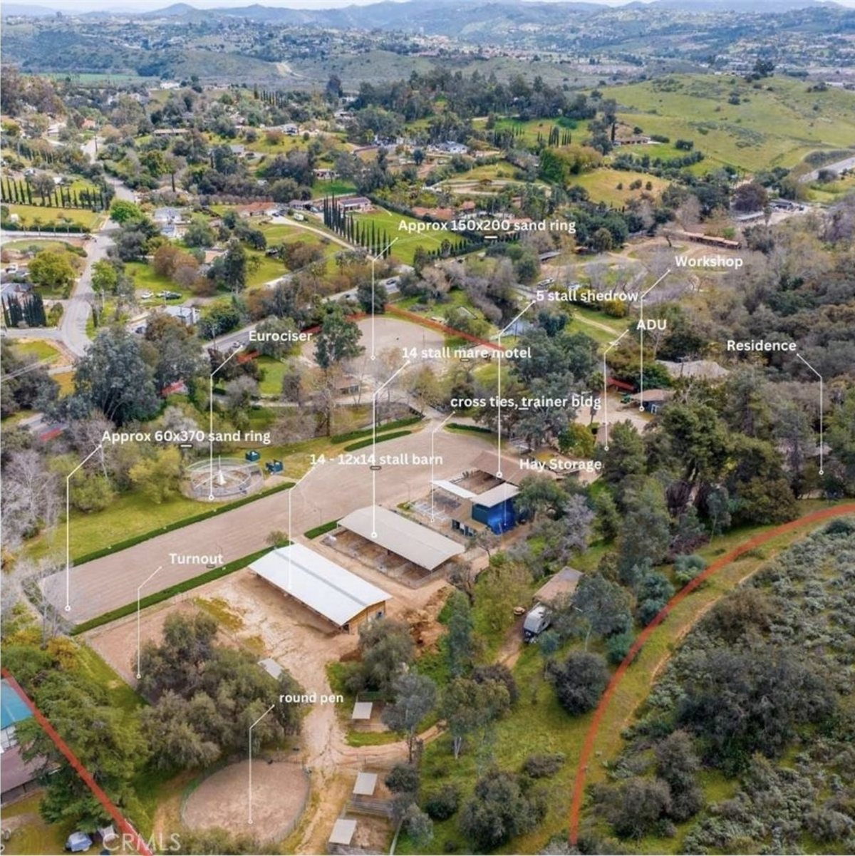 Aerial photo of the Fallbrook horse property labeled with a 150 by 200 foot sand ring, a 60 by 370 foot sand ring, a Eurociser, a 14-stall barn, a 14-stall mare motel, a 5-stall shedrow, a round pen, turnout, hay storage, a trainer building, workshop, ADU and residence