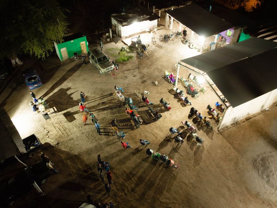 Aerial view at night of a community gathering in an ejido outside Hermosillo, Sonora